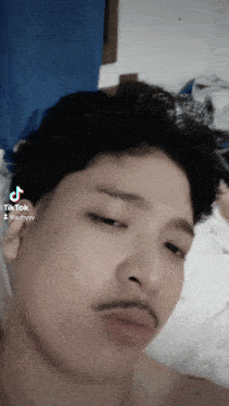 a close up of a man 's face with a tik tok watermark
