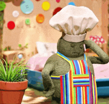 a stuffed animal with a chef 's hat and apron