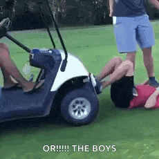 a group of people are standing around a golf cart .