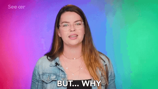 a woman wearing glasses and a denim jacket is saying but why
