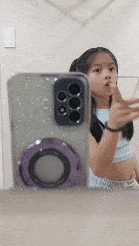 a little girl is taking a selfie with her phone