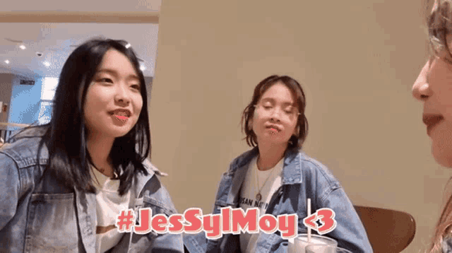 three girls are sitting at a table with the hashtag # jessyimoy3