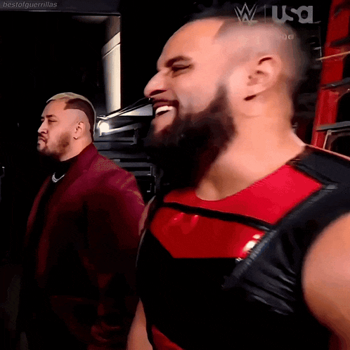 two men are standing next to each other and one of them is wearing a red shirt with the word usa on it