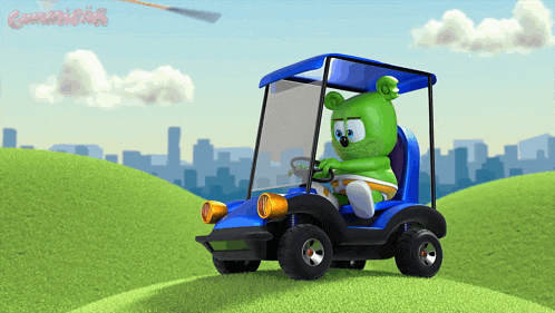a gummy bear is driving a blue golf cart on a hill