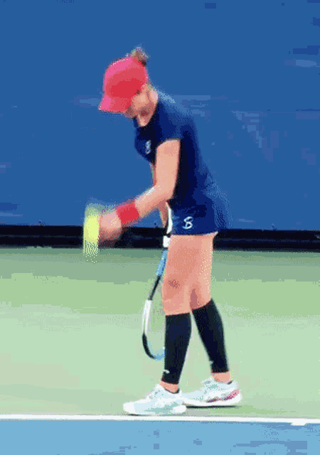 a woman playing tennis with a s on her shorts
