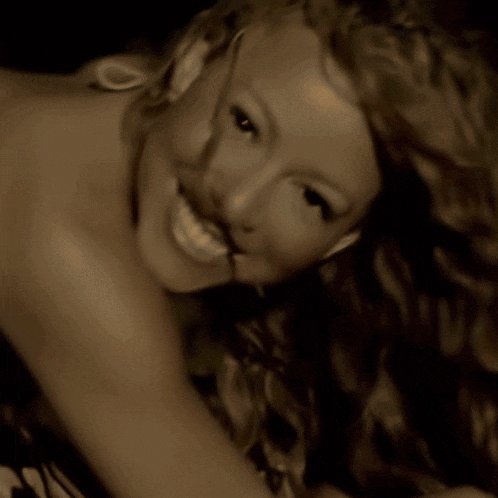 a close up of a woman 's face with a smile