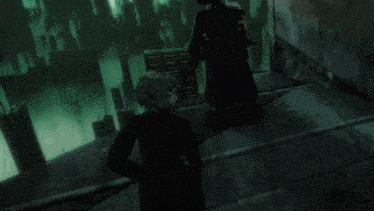 a man with a sword stands next to another man in a dark room