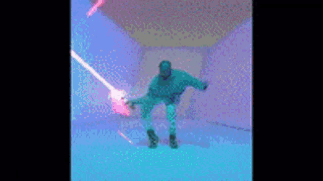 a man is dancing in a room with a lot of lights on the wall .