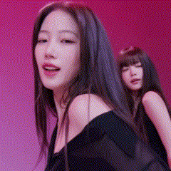 two women are dancing in front of a pink background .