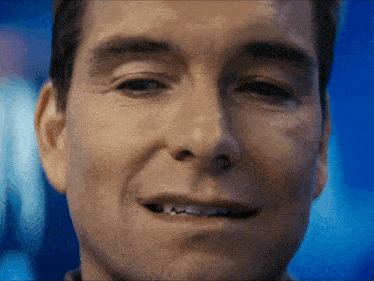 a close up of a man 's face with a smile on it
