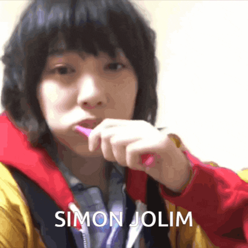 a person brushing their teeth with the name simon jolim on the bottom right