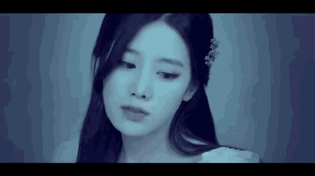 a woman with long hair and a flower in her hair