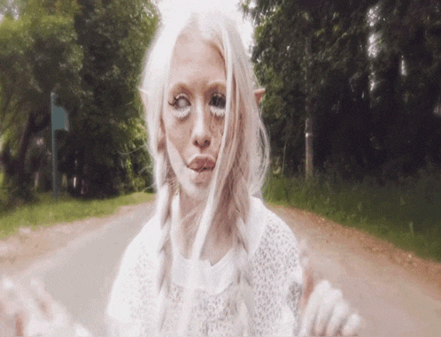 a woman with white hair and white eyes looks like an elf