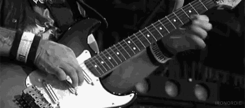 a man is playing an electric guitar in a black and white photo with iron nordic written on the bottom