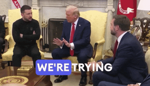 a group of men are sitting around a table with a sign saying we 're trying
