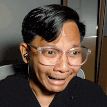a close up of a man wearing glasses and earbuds