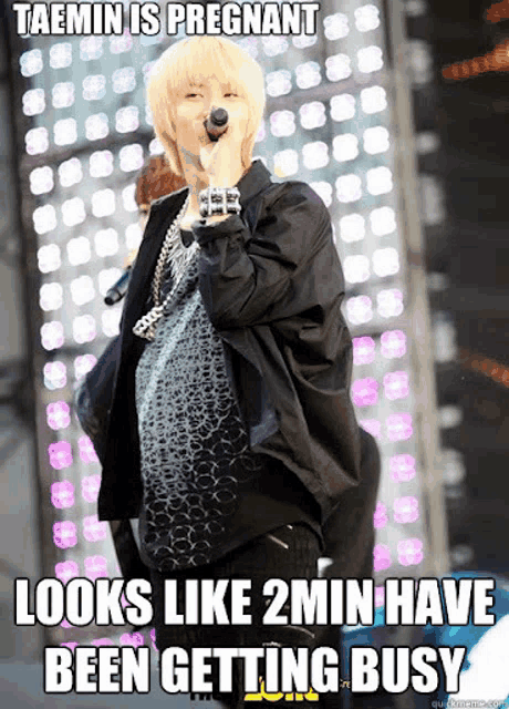 a pregnant woman singing into a microphone with the caption taemin is pregnant looks like 2min have been getting busy