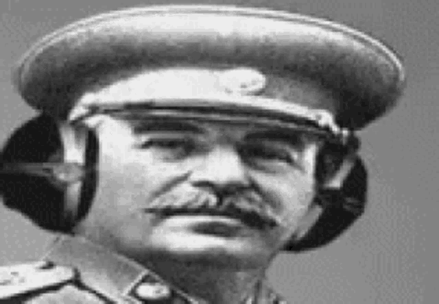 a black and white photo of a man in a military uniform wearing headphones .