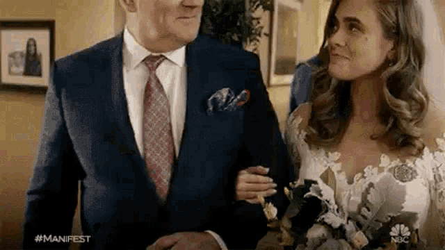 a bride and groom are walking down the aisle at their wedding .