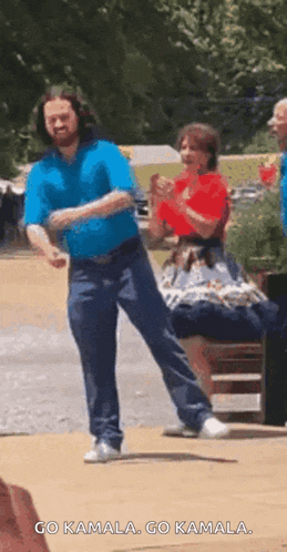 a man is dancing in front of a group of people .