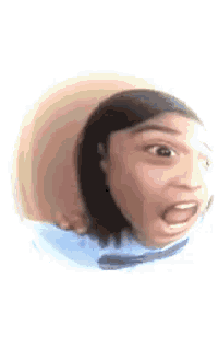 a close up of a person 's face with their mouth open and a hat on .