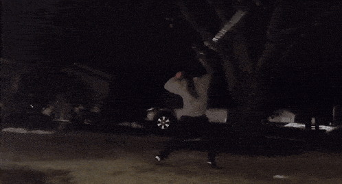 a man in a sweater is holding a flashlight in his hand