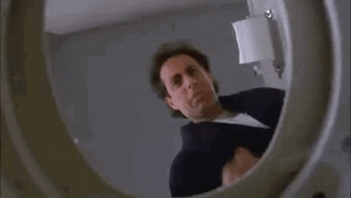 a woman in a black bra is sitting on a toilet .