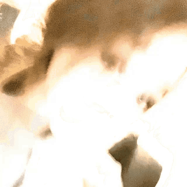 a close up of a person 's face with a blurred background