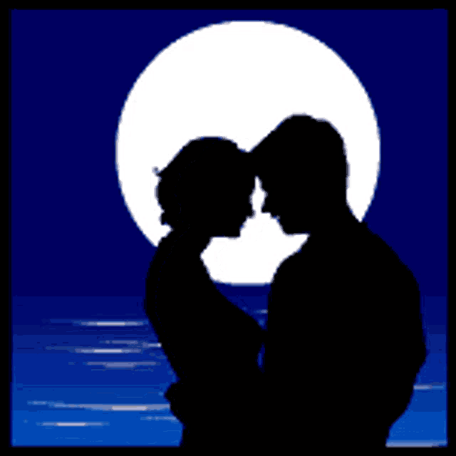 silhouette of a man and woman kissing in front of a full moon