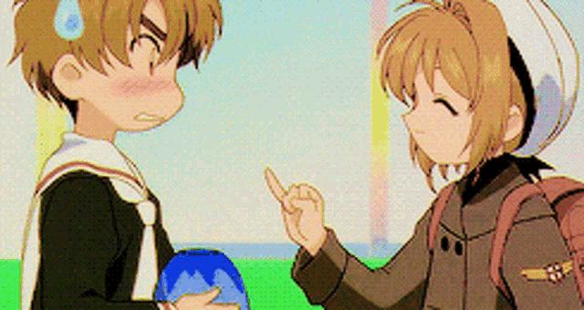 a boy and a girl are standing next to each other and the girl is pointing