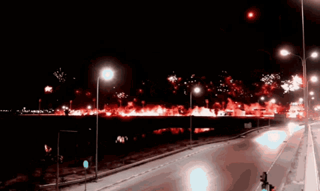 a fireworks display is going on over a bridge at night
