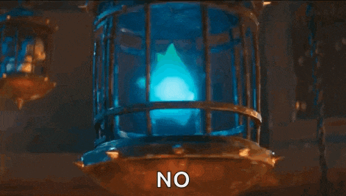 a blue cartoon character is sitting in a cage with the word no written on it .