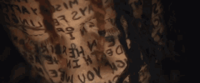 a close up of a person 's arm with a lot of writing on it