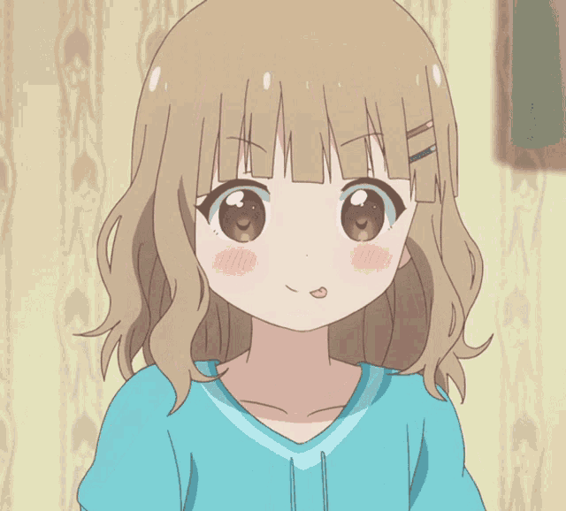a girl in a blue shirt is holding a piece of food in her hand