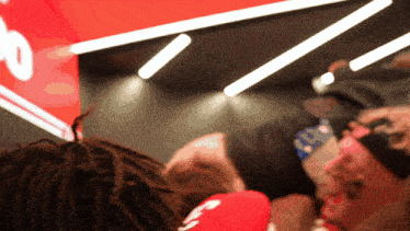 a person wearing a headband with the number 10 on it stands in front of a red sign