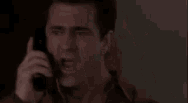 a man talking on a cell phone with the words roja xwe disa dixwazim written on the bottom