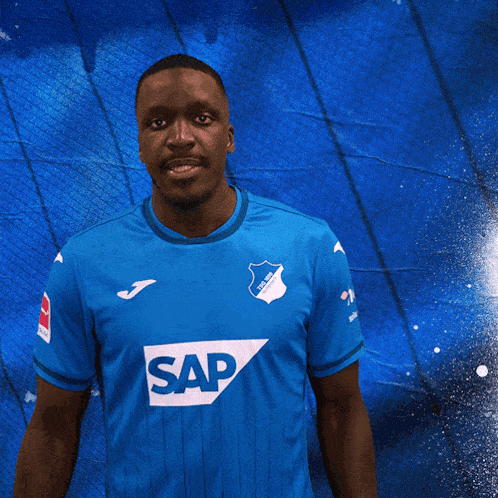 a man wearing a blue shirt that says sap on it