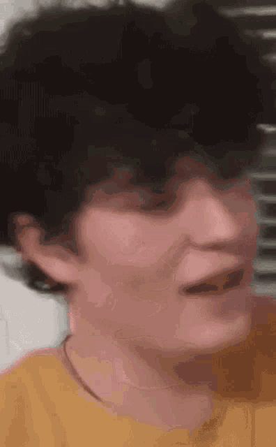 a close up of a person 's face making a funny face .