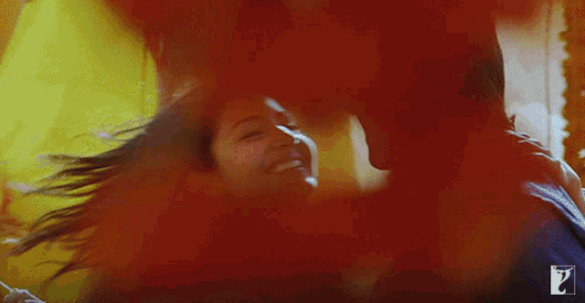 a man and a woman are hugging each other and the woman is smiling and the man is holding her