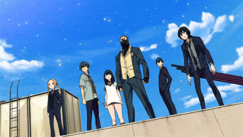 a group of people standing on top of a building with a blue sky behind them