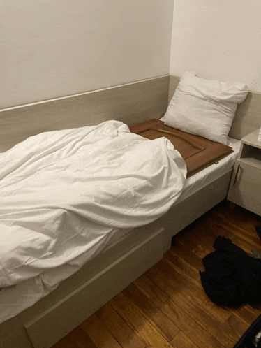 a bed with a pillow and a door on it