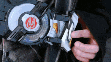 a close up of a person holding a toy with a red and white logo