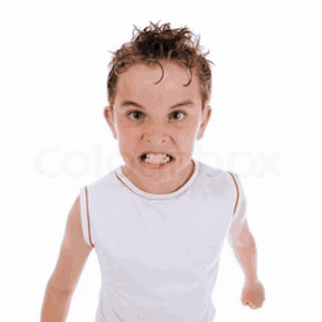 a young boy in a white tank top is making a very angry face