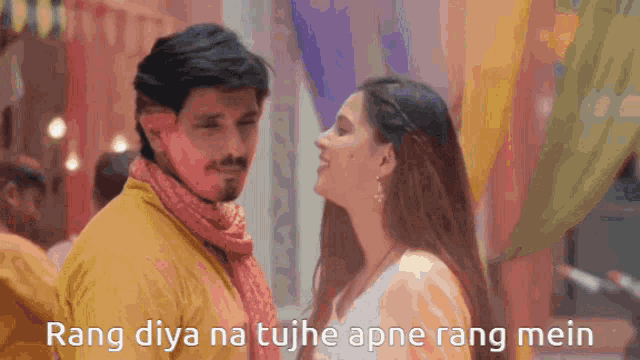 a man and a woman are looking at each other with the words rang diya na tujh apne rang mein above them