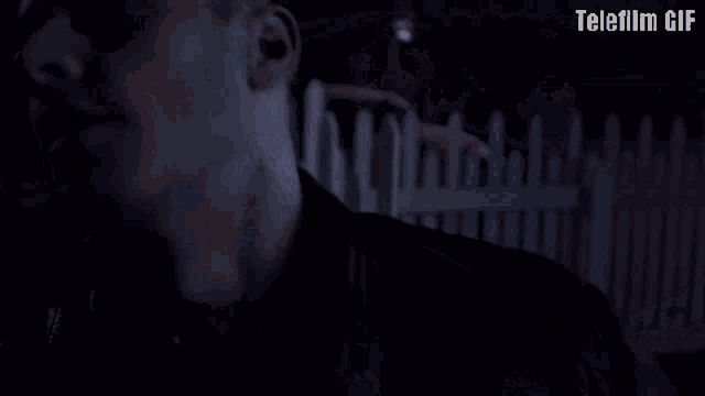 a gif of a man laying on a porch with the words telefilm gif below him