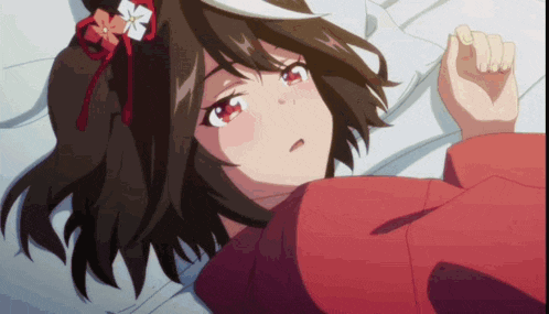 a close up of a girl laying on a bed with a flower in her hair