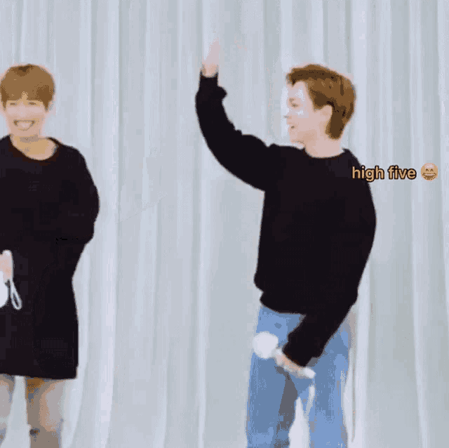 a man giving another man a high five with a high five emoji behind him