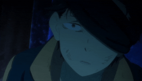 a close up of a man 's face in the dark