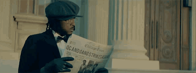 a man wearing a hat and gloves is reading a chicago times newspaper