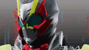 a close up of a masked rider 's face with red eyes